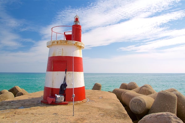 Ilha de Tavira Beach featuring a lighthouse and general coastal views