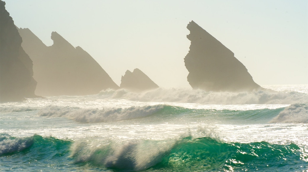 Adraga Beach which includes general coastal views, surf and rocky coastline