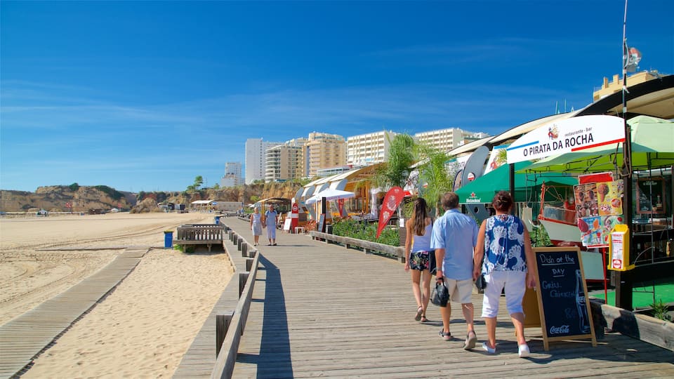 Rocha Beach which includes a coastal town, a sandy beach and general coastal views
