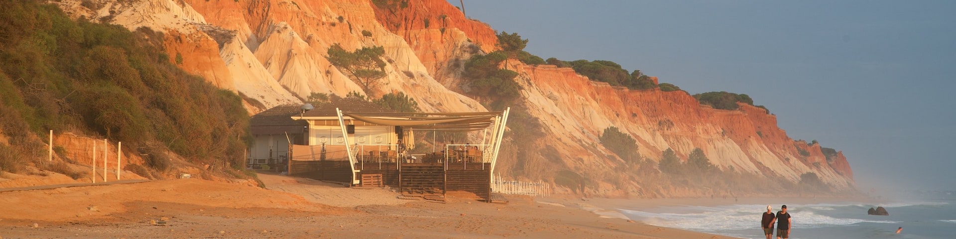 Falesia Beach which includes a sandy beach, rugged coastline and general coastal views