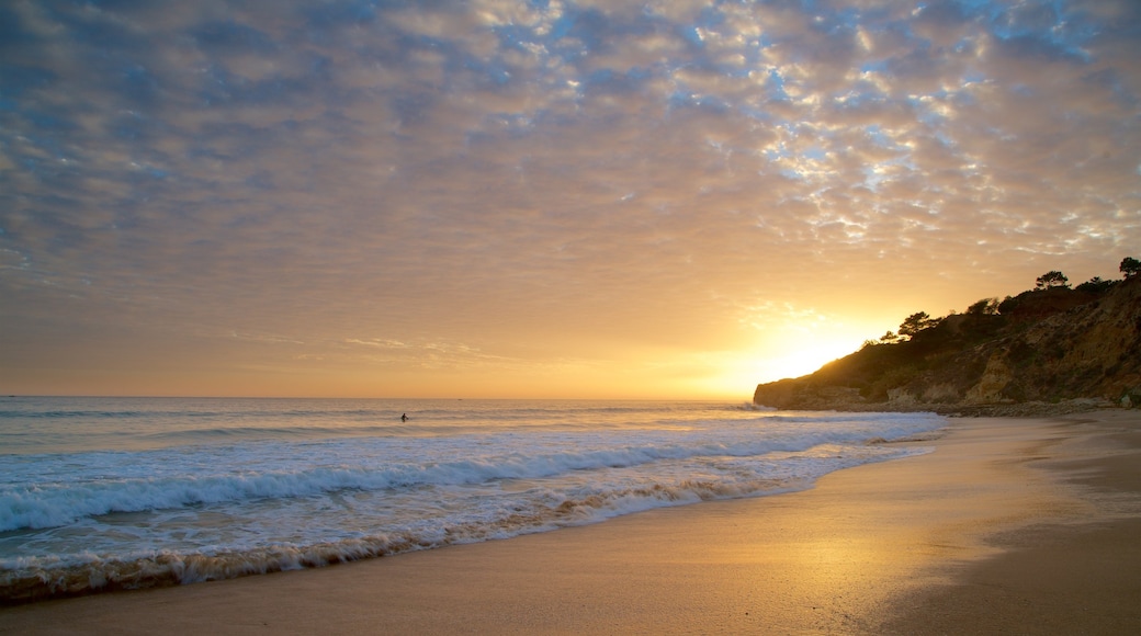 Falesia Beach which includes rugged coastline, a sunset and general coastal views