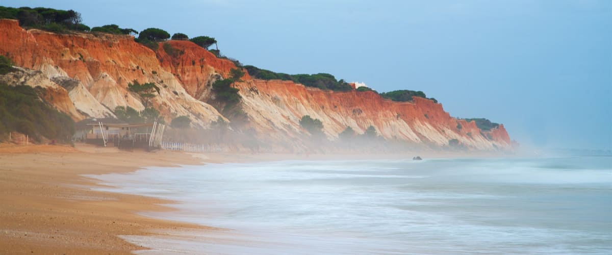 Falesia Beach featuring rocky coastline, general coastal views and a sandy beach