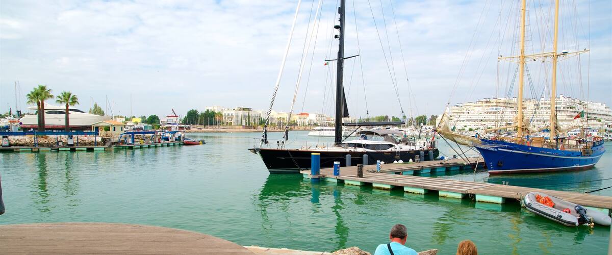 Vilamoura Marina which includes a bay or harbour as well as a couple
