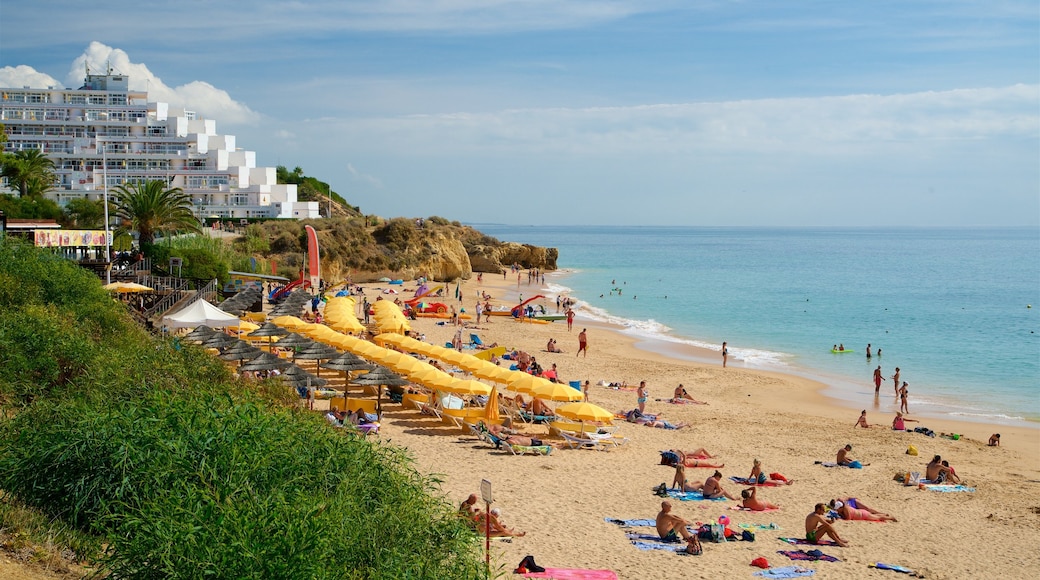 Oura Beach which includes a beach, a coastal town and general coastal views