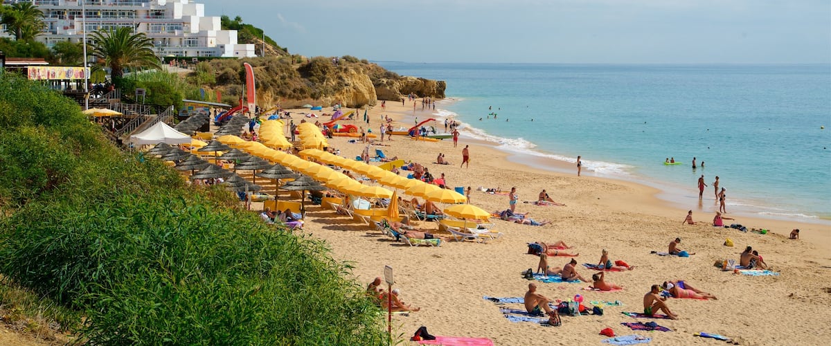Oura Beach showing general coastal views, a coastal town and a sandy beach