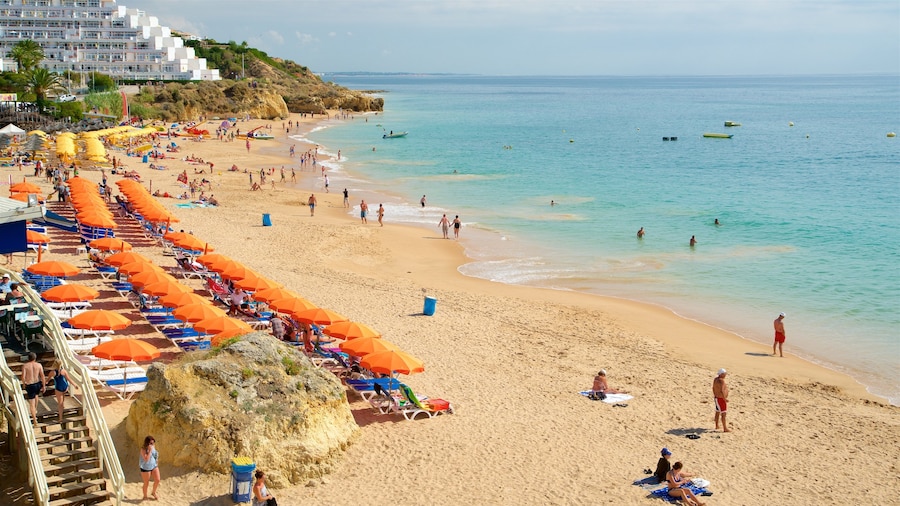 Oura Beach which includes general coastal views, a sandy beach and swimming
