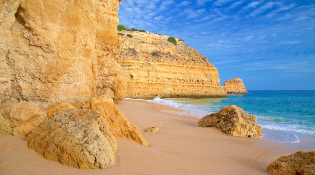 Marinha Beach which includes general coastal views, a sandy beach and rocky coastline