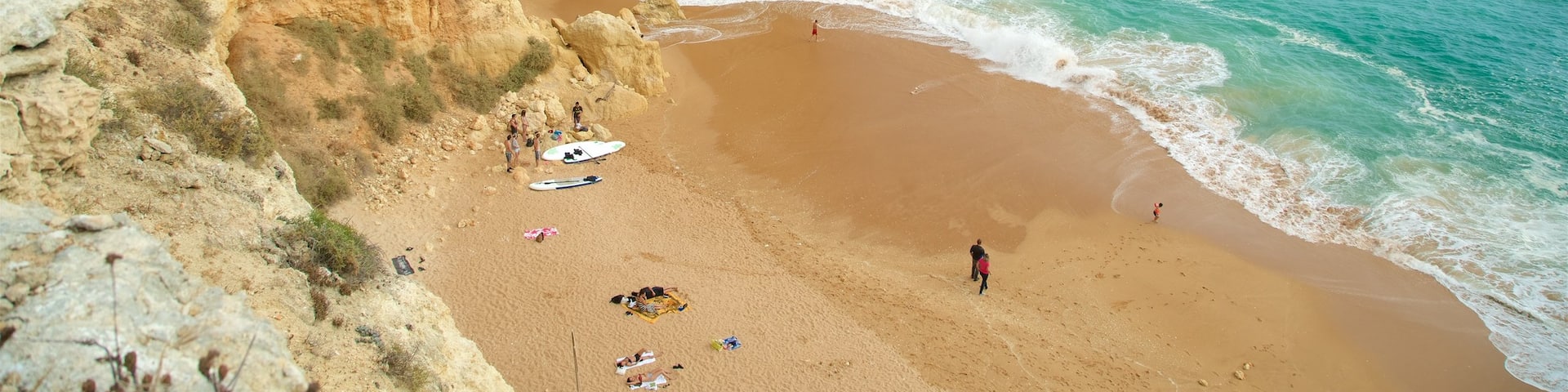 Benagil Beach featuring a beach, rugged coastline and general coastal views