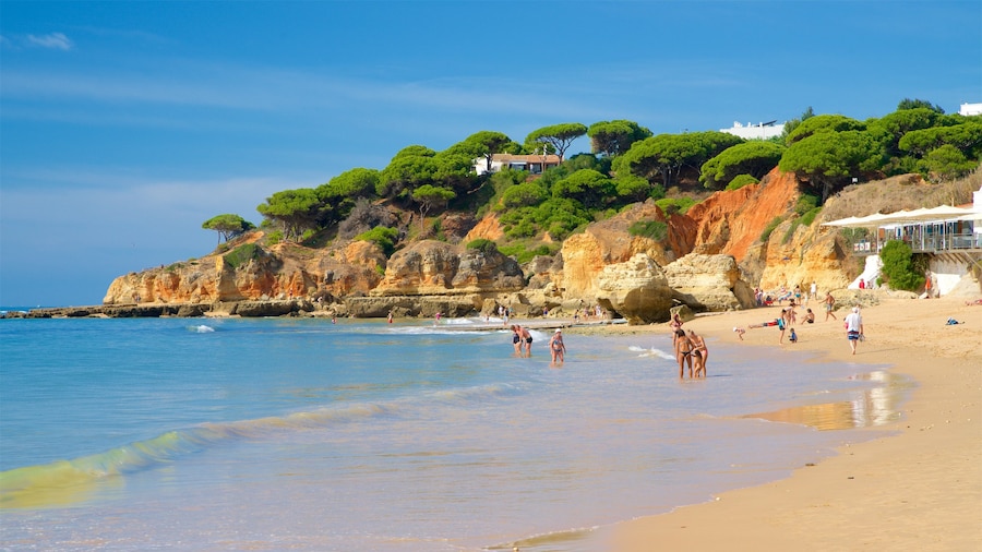 Olhos D\'Agua Beach featuring a beach, rocky coastline and general coastal views