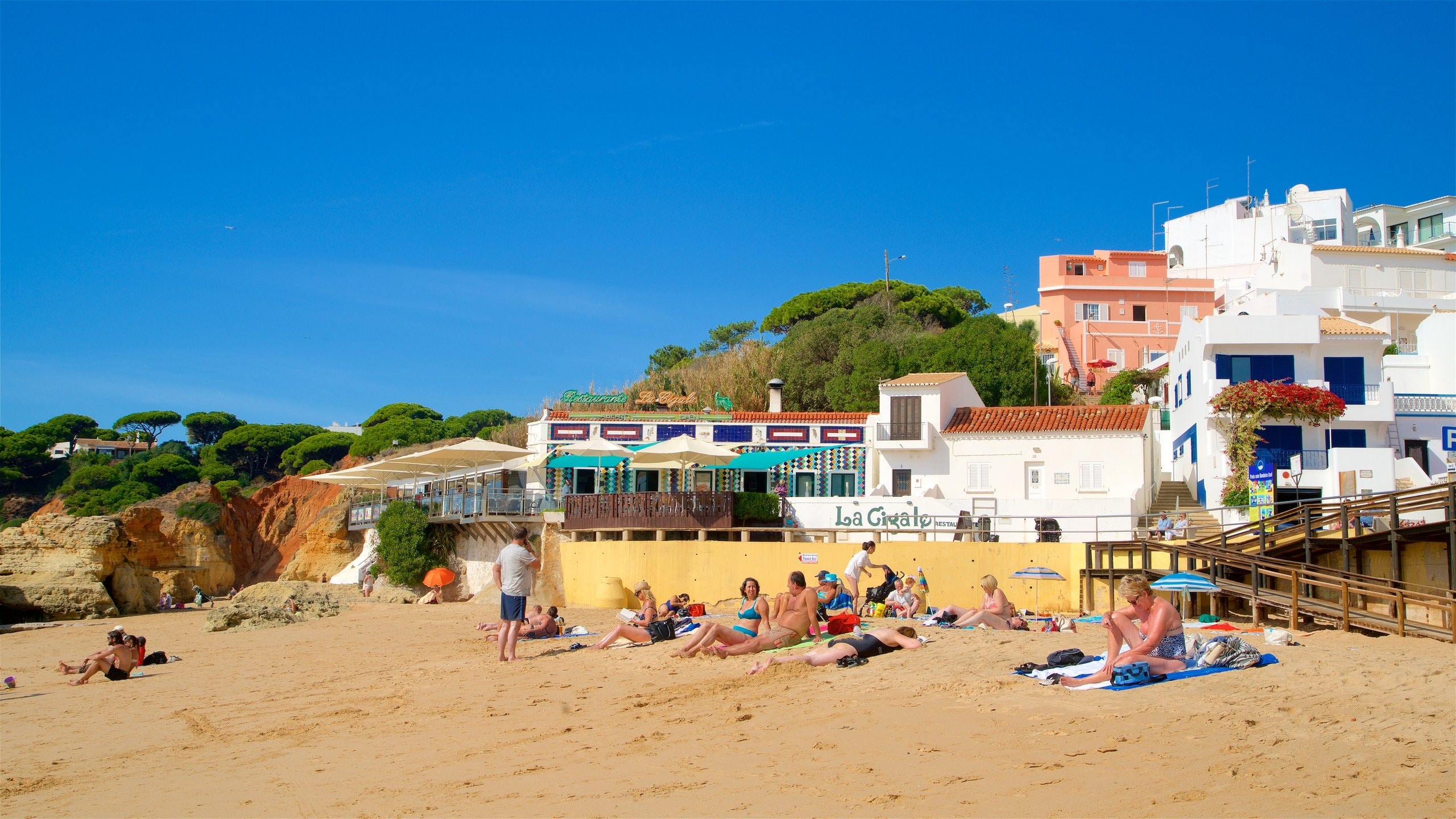 Olhos D\'Agua Beach showing general coastal views and a sandy beach as well as a small group of people
