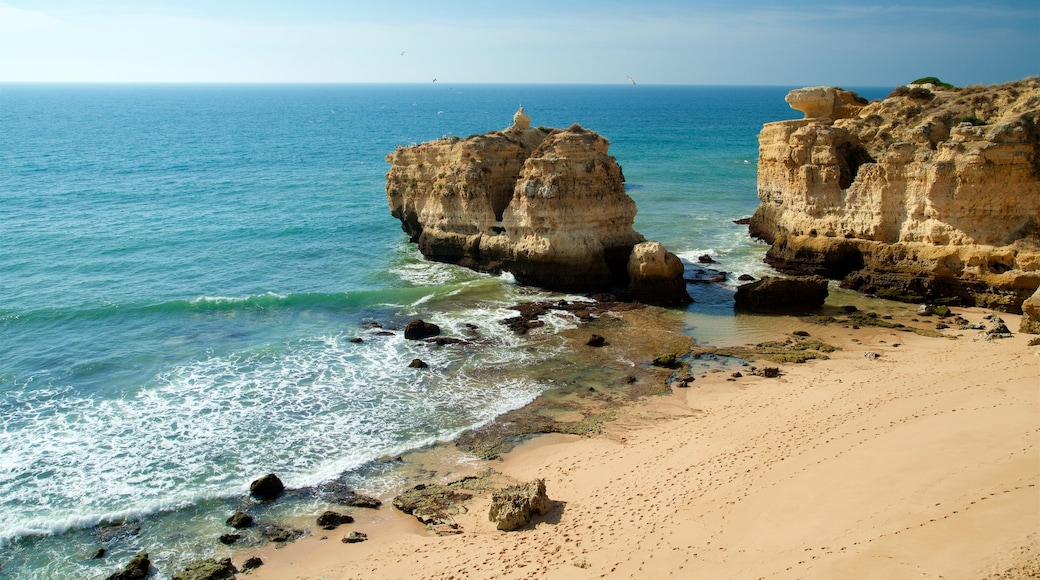 Coelha Beach featuring rocky coastline, a sandy beach and general coastal views