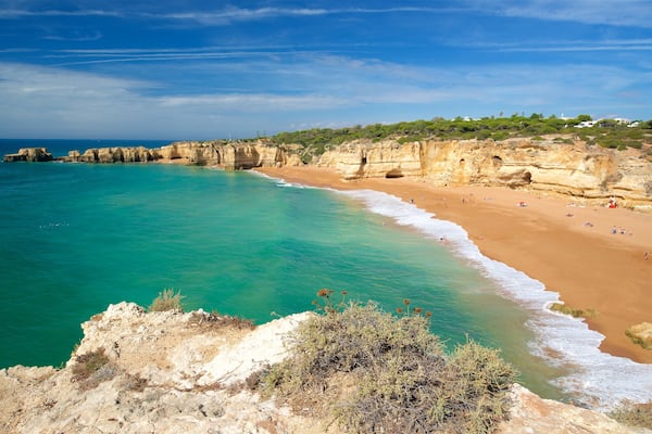 Coelha Beach featuring general coastal views, rocky coastline and a sandy beach