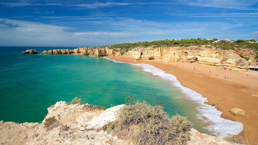 Coelha Beach showing rocky coastline, general coastal views and a sandy beach