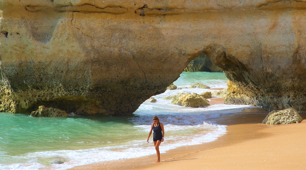 Coelha Beach which includes rugged coastline, a beach and general coastal views