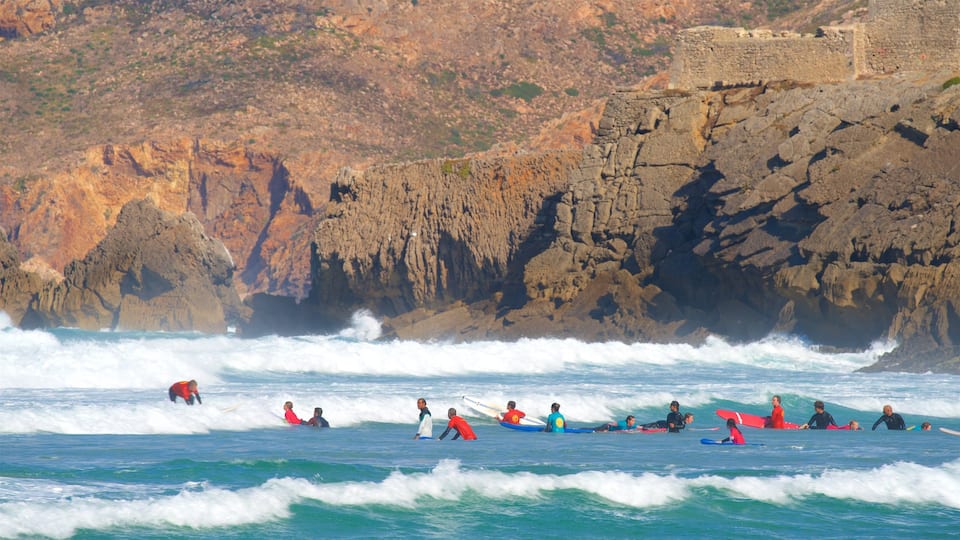 Guincho Beach which includes general coastal views, surfing and rocky coastline