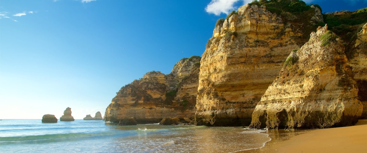Dona Ana Beach featuring rocky coastline, a beach and general coastal views