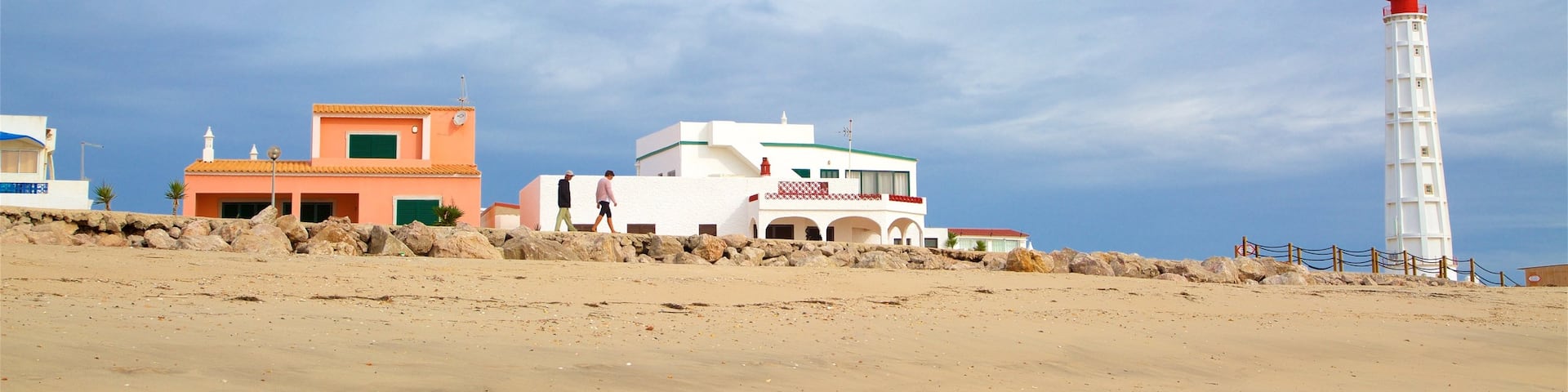 Faro Island Beach showing a beach and a lighthouse