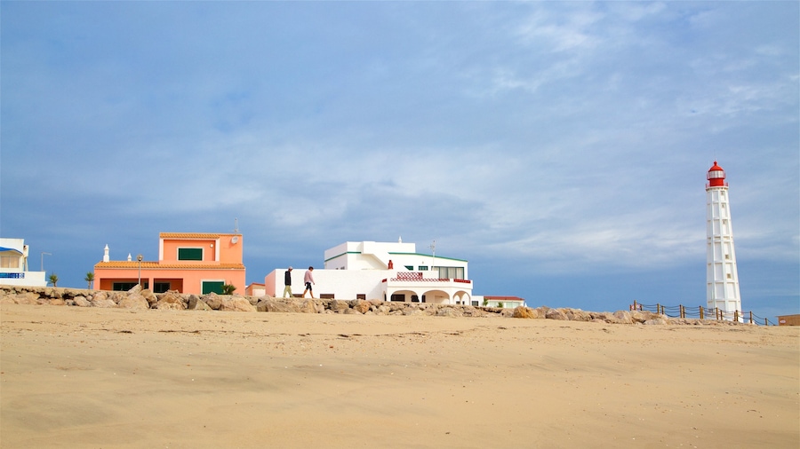 Faro Island Beach featuring a lighthouse and a beach