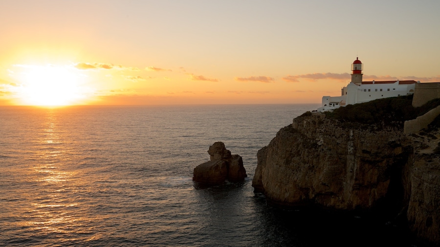 Cape St. Vincent Lighthouse featuring a lighthouse, rocky coastline and a sunset