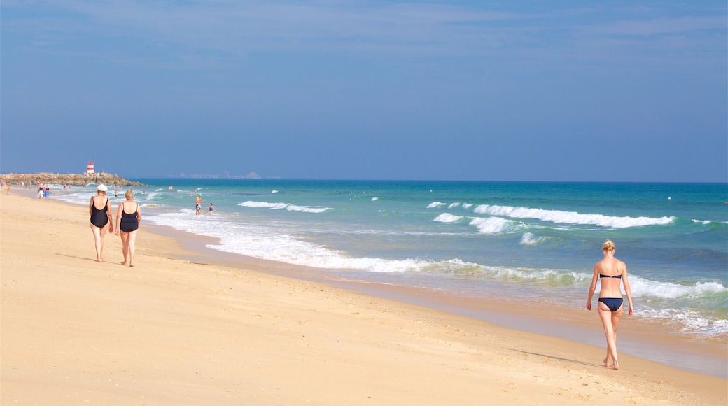 Ilha de Tavira Beach featuring a sandy beach and general coastal views as well as an individual female