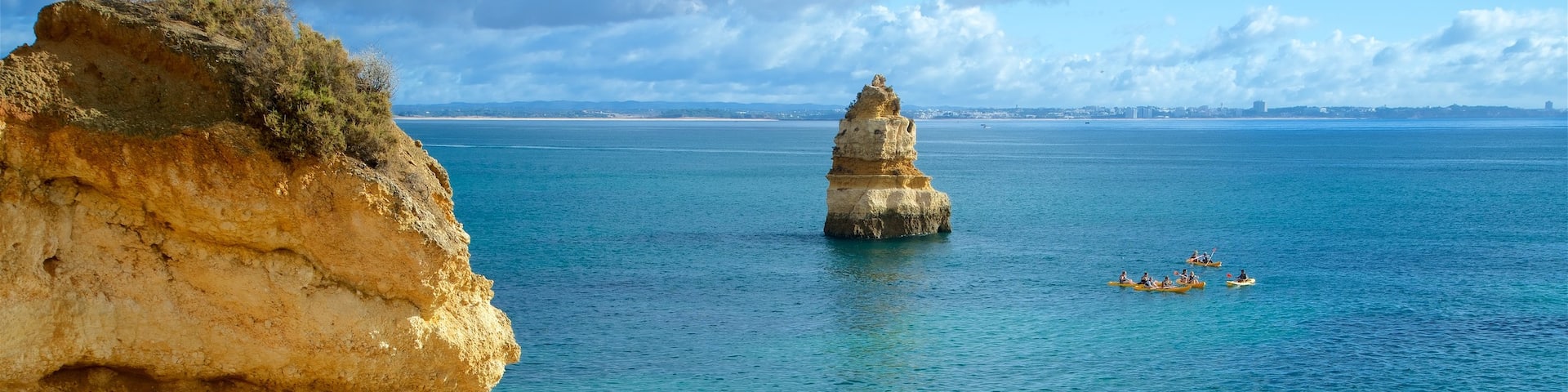 Camilo Beach which includes general coastal views, rugged coastline and a sandy beach