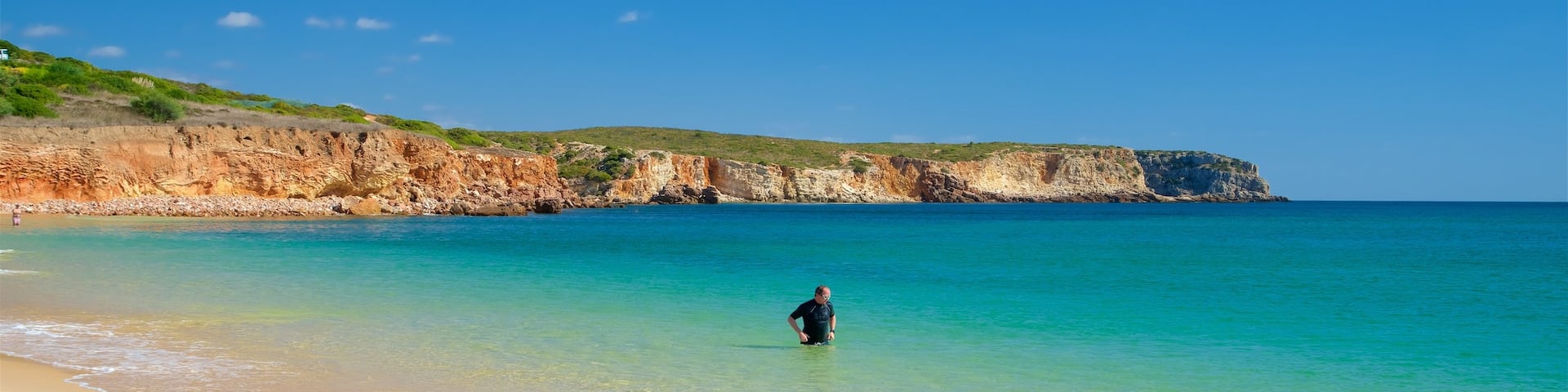 Martinhal Beach which includes rocky coastline, swimming and general coastal views