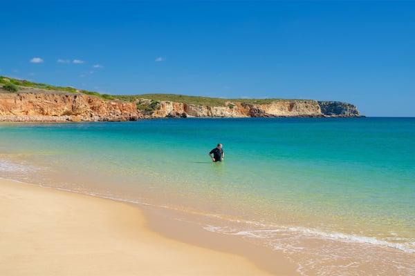 Martinhal Beach showing rugged coastline, swimming and general coastal views