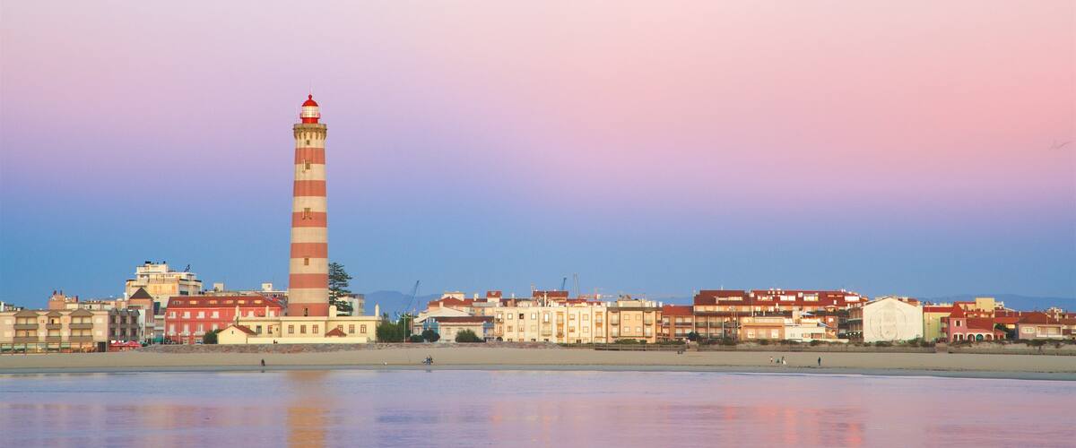 Barra Beach which includes a coastal town, general coastal views and a lighthouse