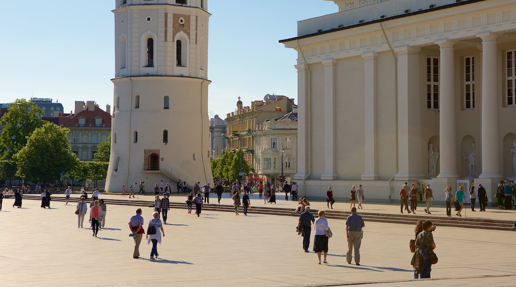 Cathedral Square showing a square or plaza and heritage elements as well as a small group of people