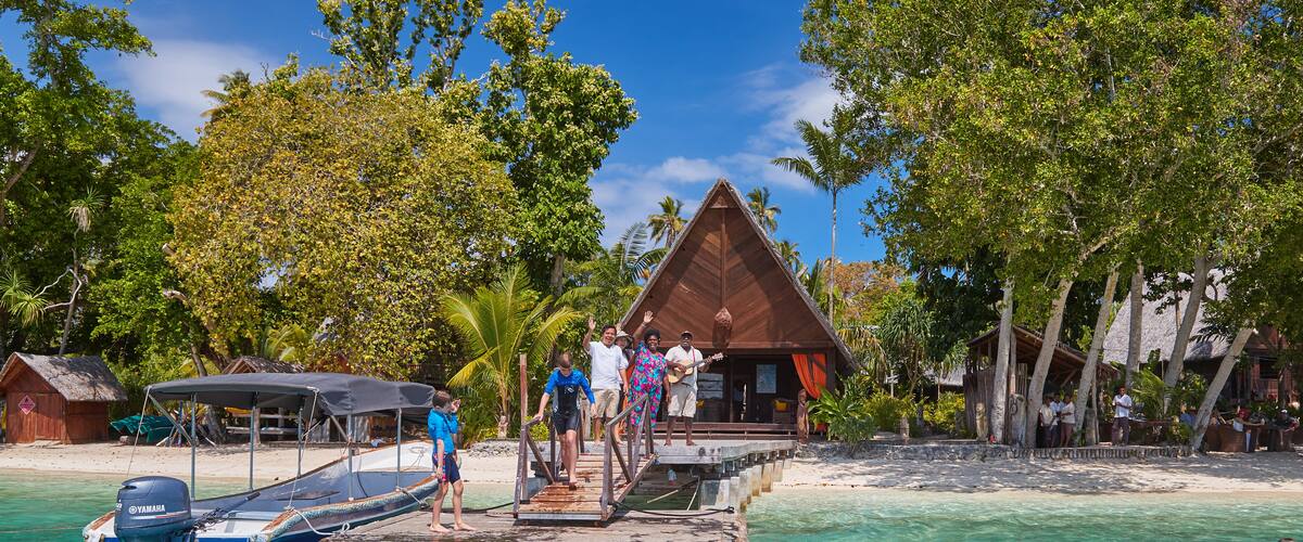 Ratua Island which includes a beach and tropical scenes as well as a small group of people