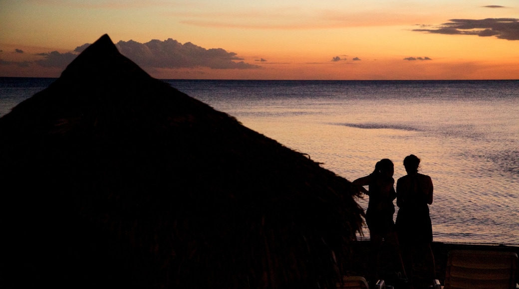 Ancon Beach which includes a sunset and general coastal views as well as a couple