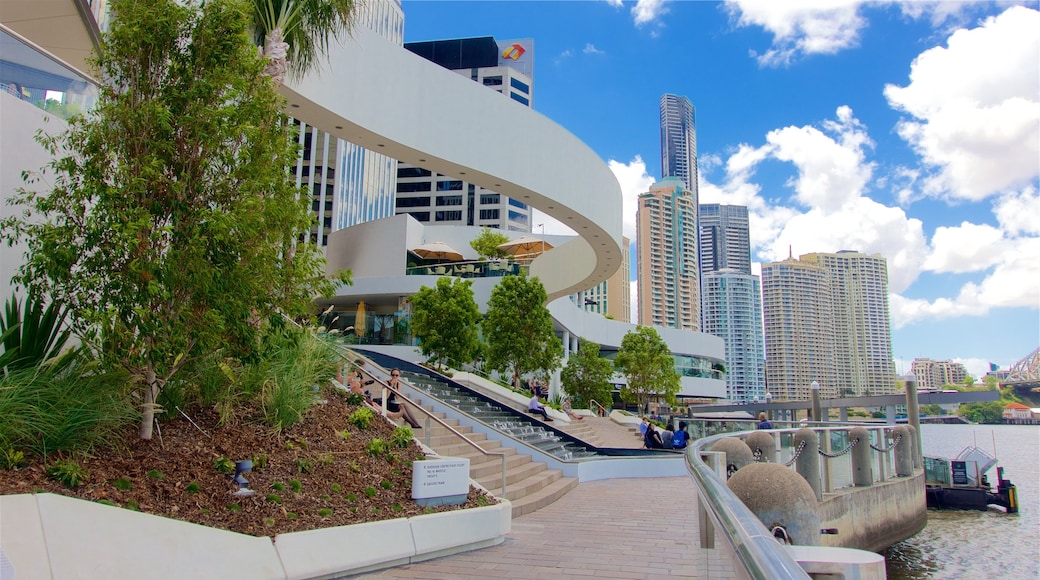 Eagle Street Pier which includes a city, a river or creek and a high-rise building