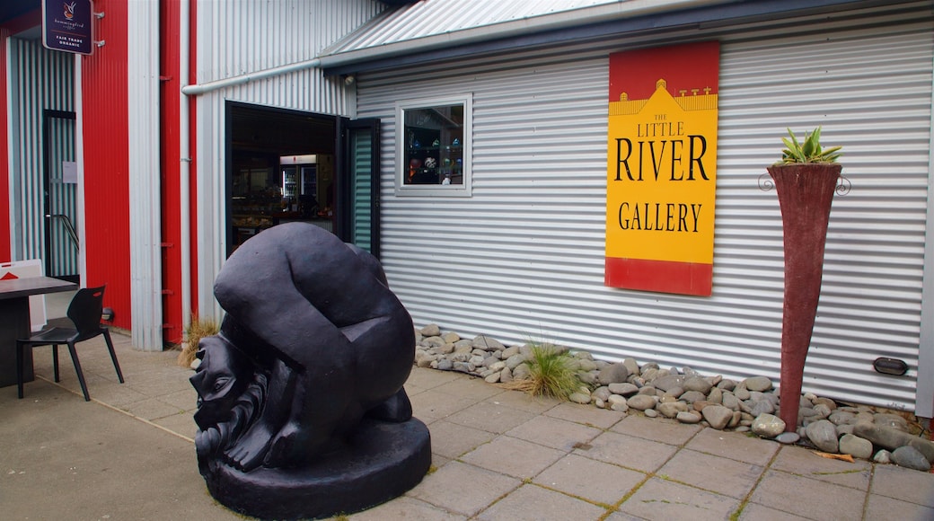 Little River featuring signage and outdoor art