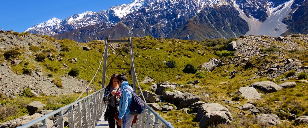 Mount Cook National Park featuring a bridge, tranquil scenes and mountains