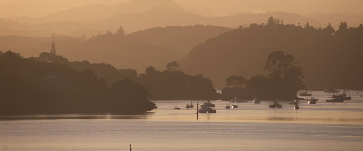 Paihia showing a bay or harbor, a sunset and tranquil scenes
