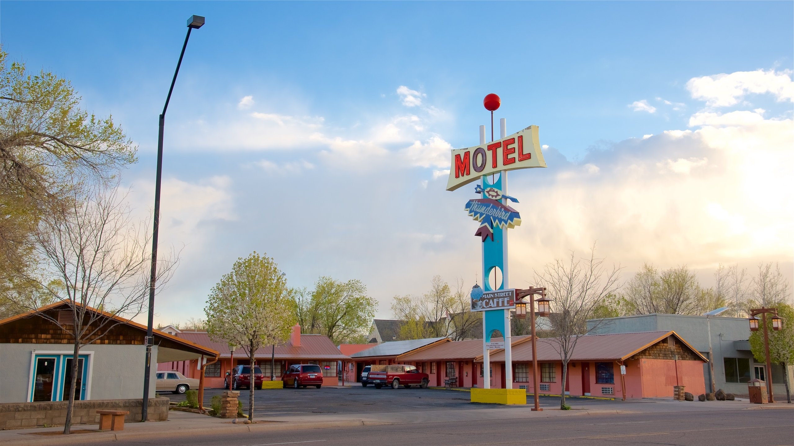 Show Low which includes signage and a sunset