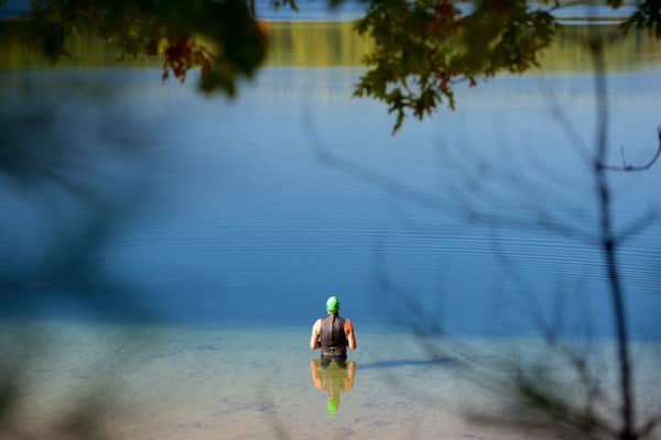 Walden Pond showing a pond and swimming as well as an individual male