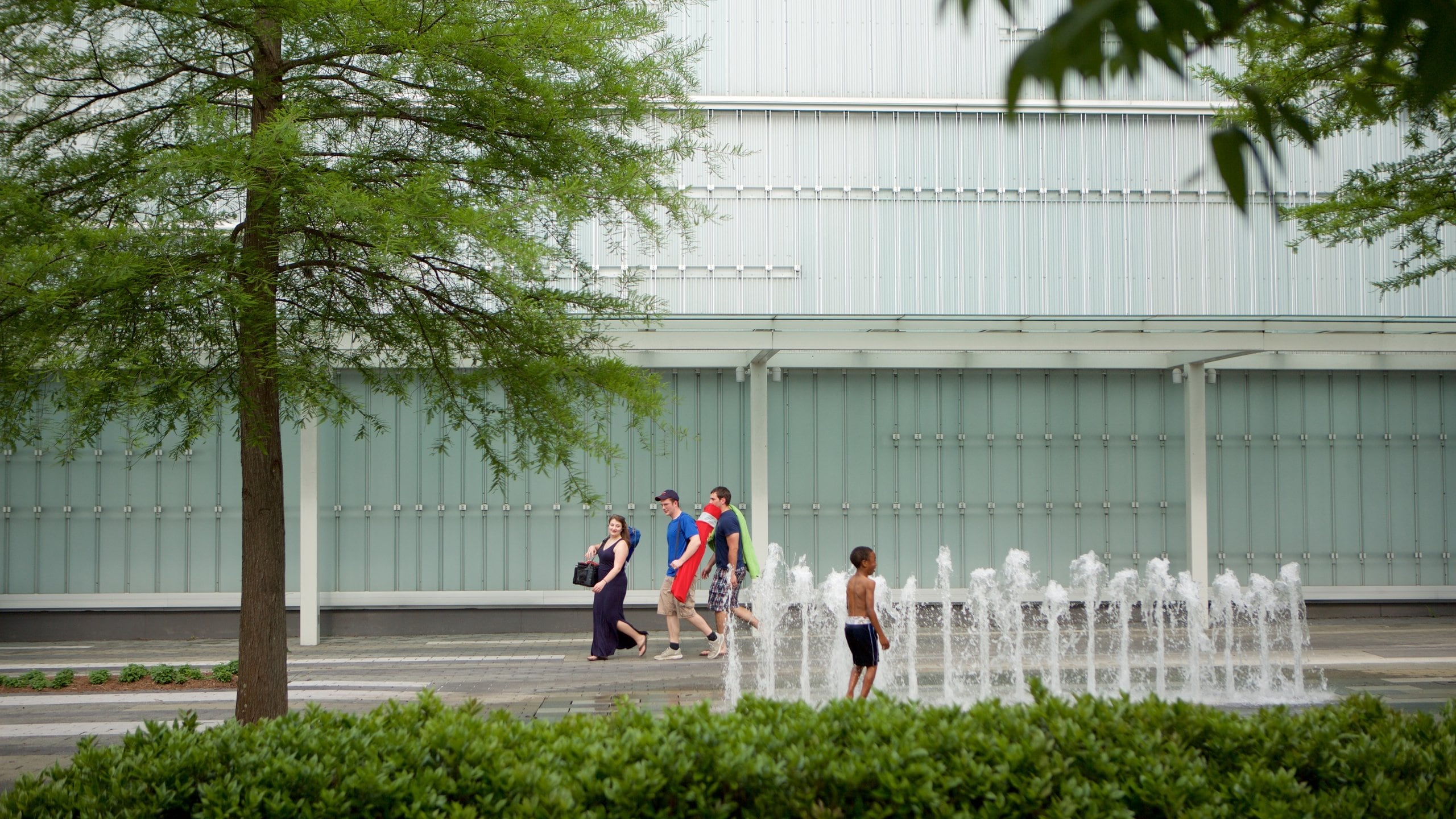 Shaw Center for the Arts showing a fountain as well as a small group of people