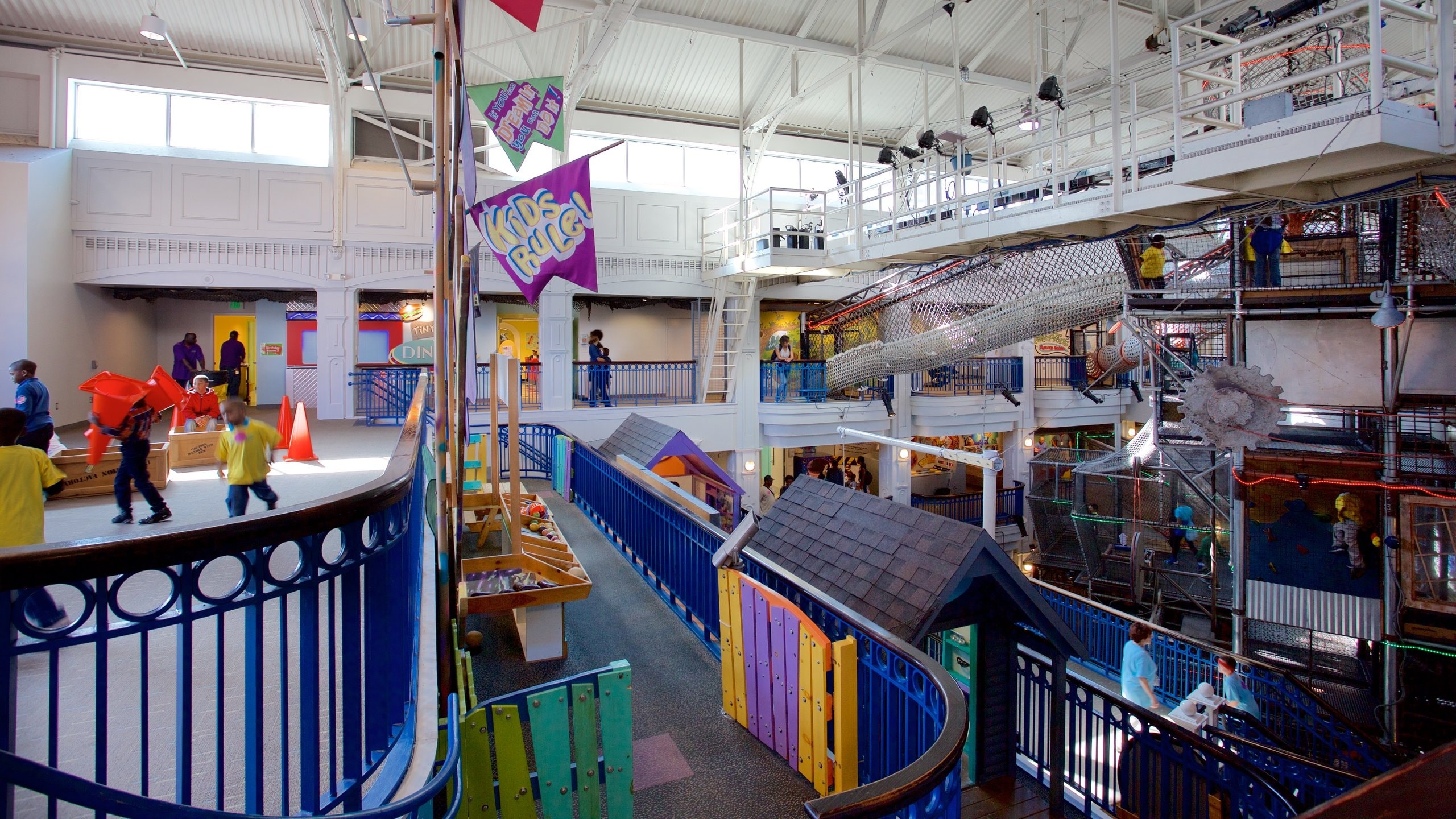 Port Discovery featuring interior views and a playground as well as children