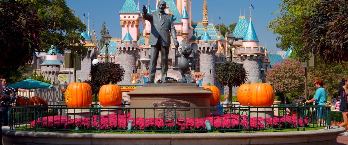 Disneyland® Park which includes rides, flowers and a statue or sculpture