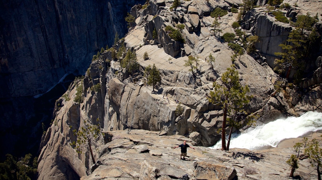 Yosemite Falls showing a gorge or canyon and a waterfall as well as an individual male