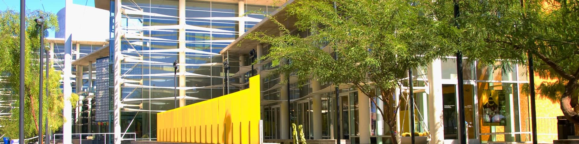 Mesa Arts Center showcases modern architecture in Mesa Arizona under bright blue skies and lush greenery