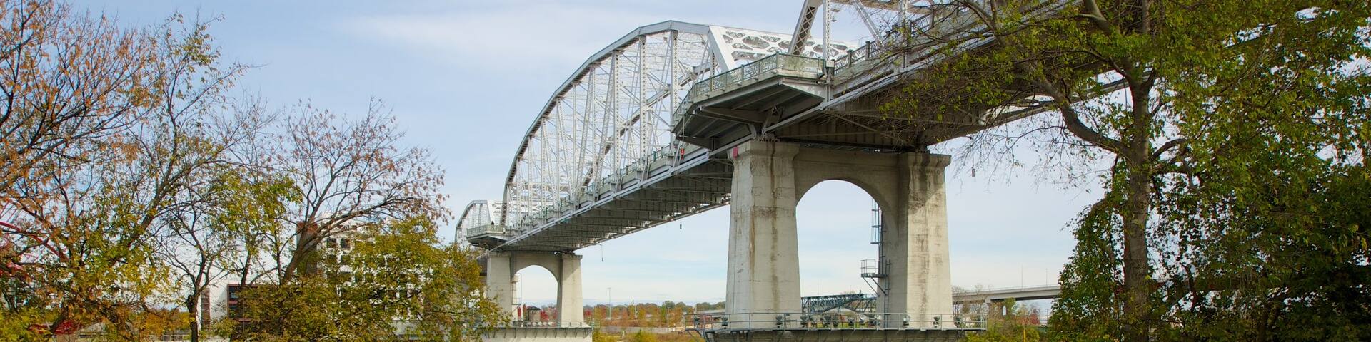 Riverfront Park which includes a park, a river or creek and a bridge