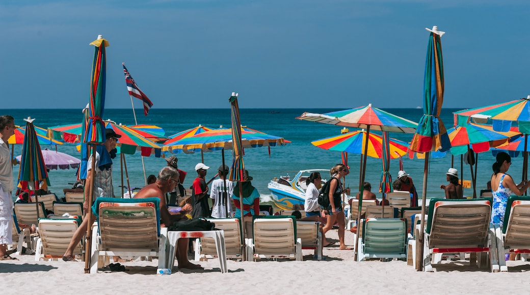 Patong showing a sandy beach as well as a large group of people