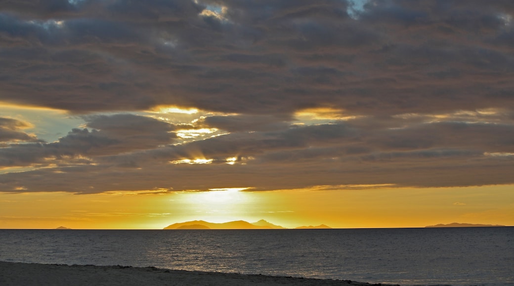 Beachcomber Island featuring a sandy beach, a sunset and landscape views