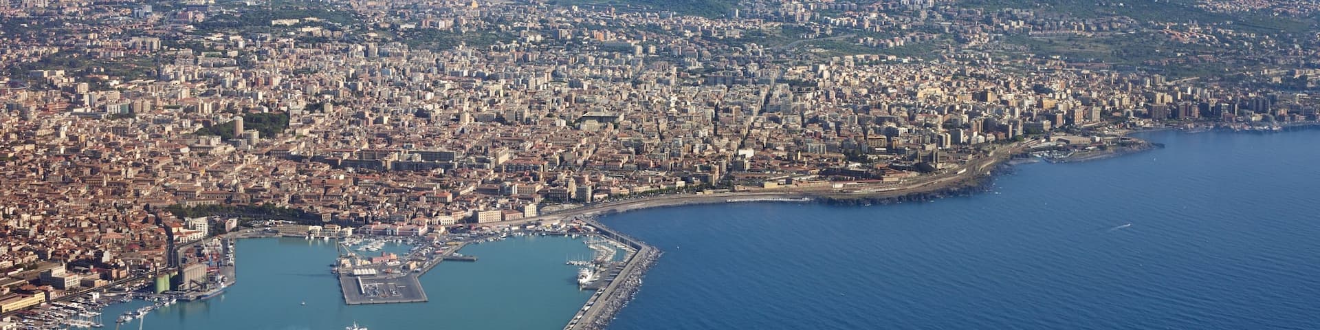 Mount Etna showing a city, mountains and general coastal views