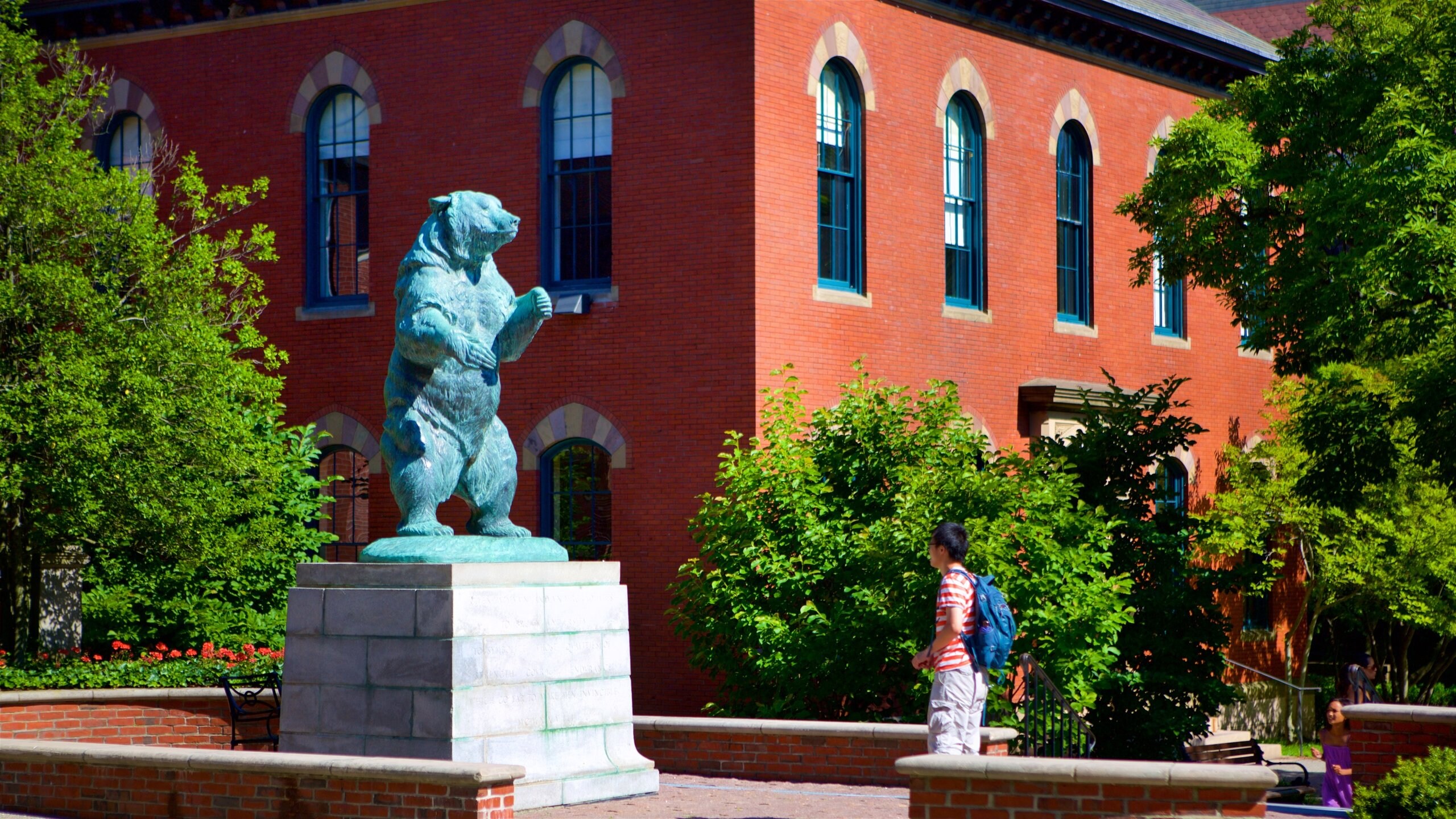 Providence featuring a statue or sculpture and a garden as well as an individual male