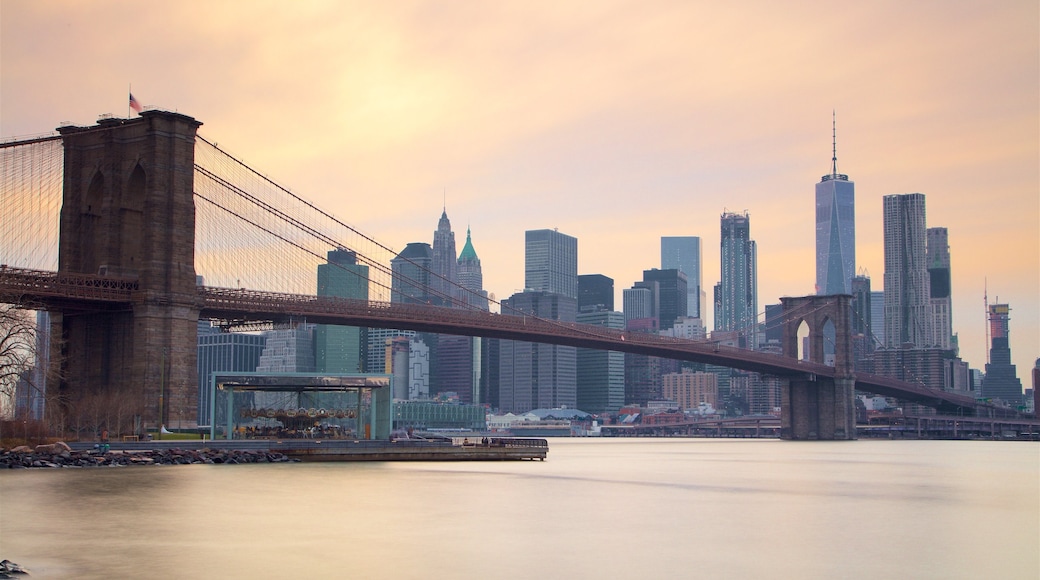 Brooklyn Bridge featuring a city, a sunset and a river or creek