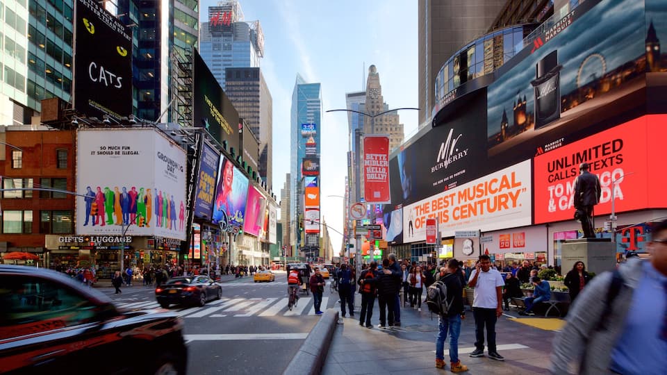 Times Square which includes a high-rise building, signage and a city
