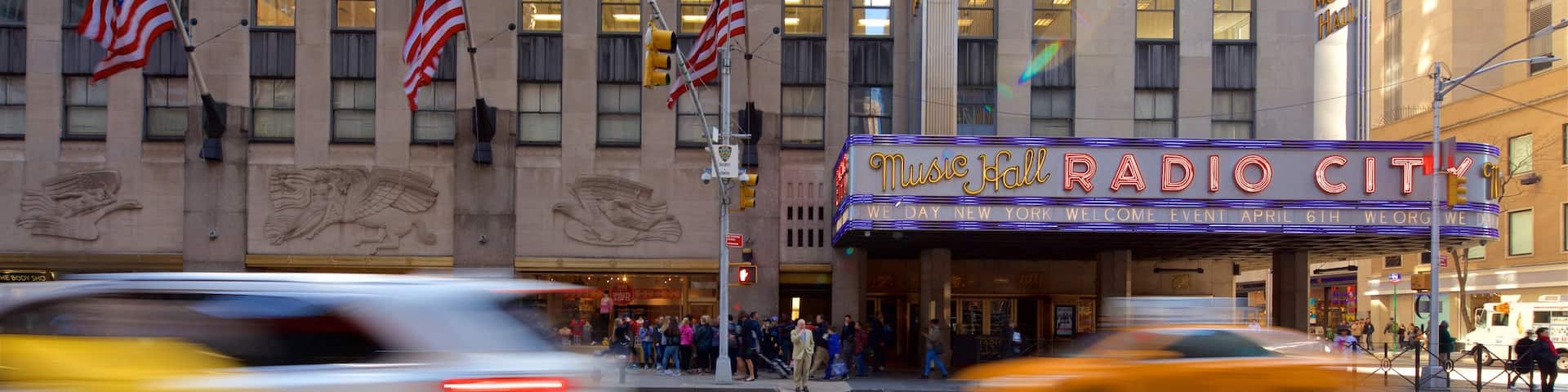 Radio City Music Hall featuring signage and a city